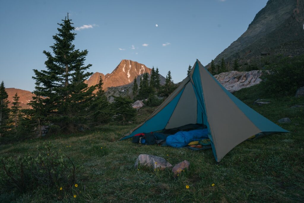 tent with mountains at sunset in colorado