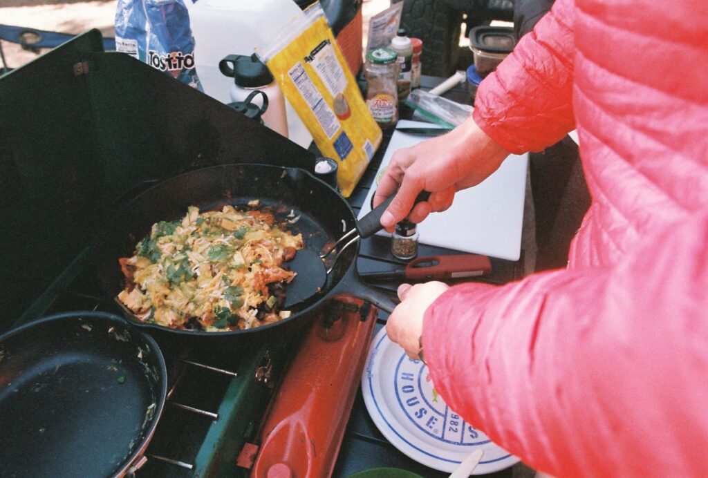 cooking meal on camp stove